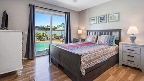 A bedroom with a bed, bedside tables, a ceiling fan, a view of a pool, and a balcony. - Relax at this Family Home w/ Solar heated Pool & Game Room. Close to everything! (San Diego)