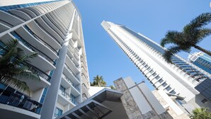 A modern high-rise building with multiple balconies and a clear blue sky. - Chevron Renaissance-Resort Style Living managed by Gold Coast Premium (Surfers Paradise)