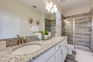 Bathtub, hair dryer, towels, shampoo