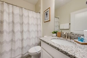 Bathtub, hair dryer, towels, shampoo