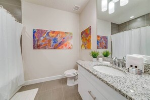 Bathtub, hair dryer, towels, shampoo