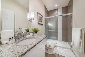 Bathtub, hair dryer, towels, shampoo