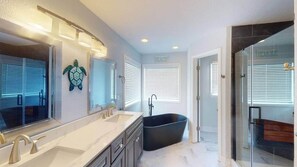 Bathtub, towels, soap, toilet paper