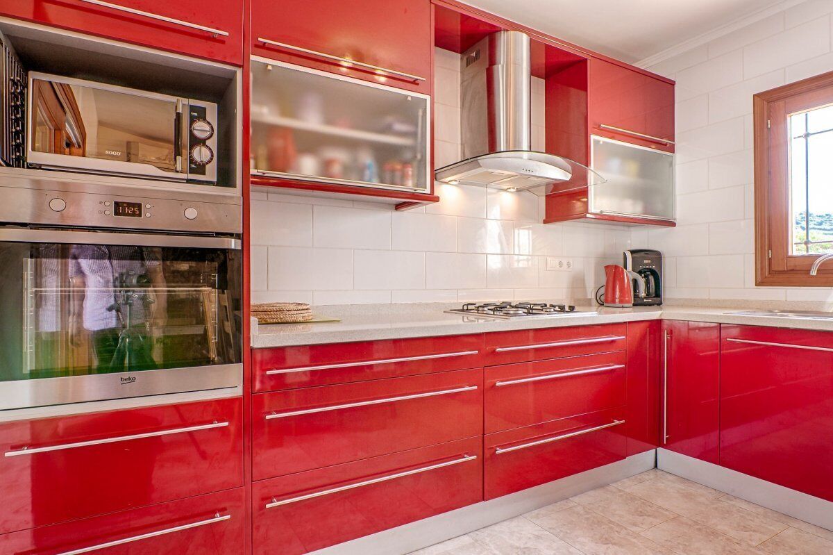 Kitchen with dishwasher oven and microwave. 3 refrigerators and a freezer.