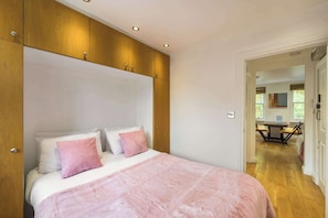 Relax in a spacious bedroom with a large bed and comfortable seating area.