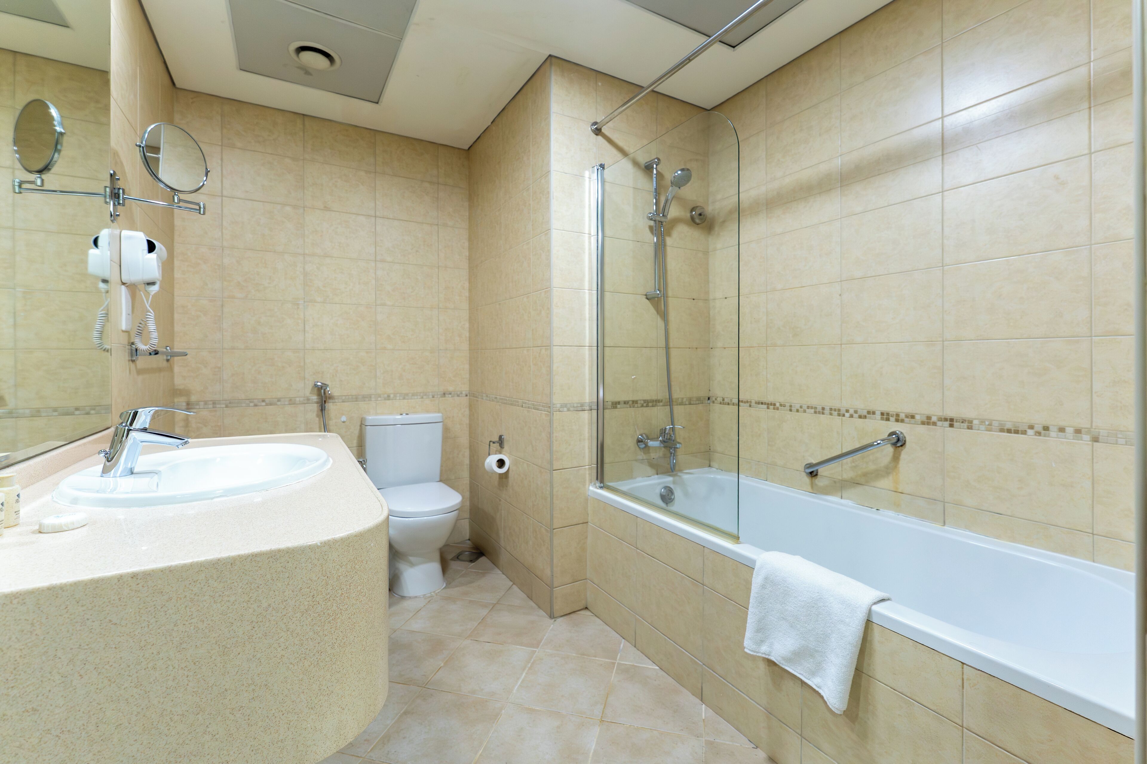 A bathroom with a sink, toilet, and bathtub.