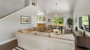 A spacious living room with a sectional sofa, a dining area with a table and chairs, and a staircase leading to an upper level. - New Build, Pet Friendly, A/C, 5 Minutes to Downtown Durango (Durango)