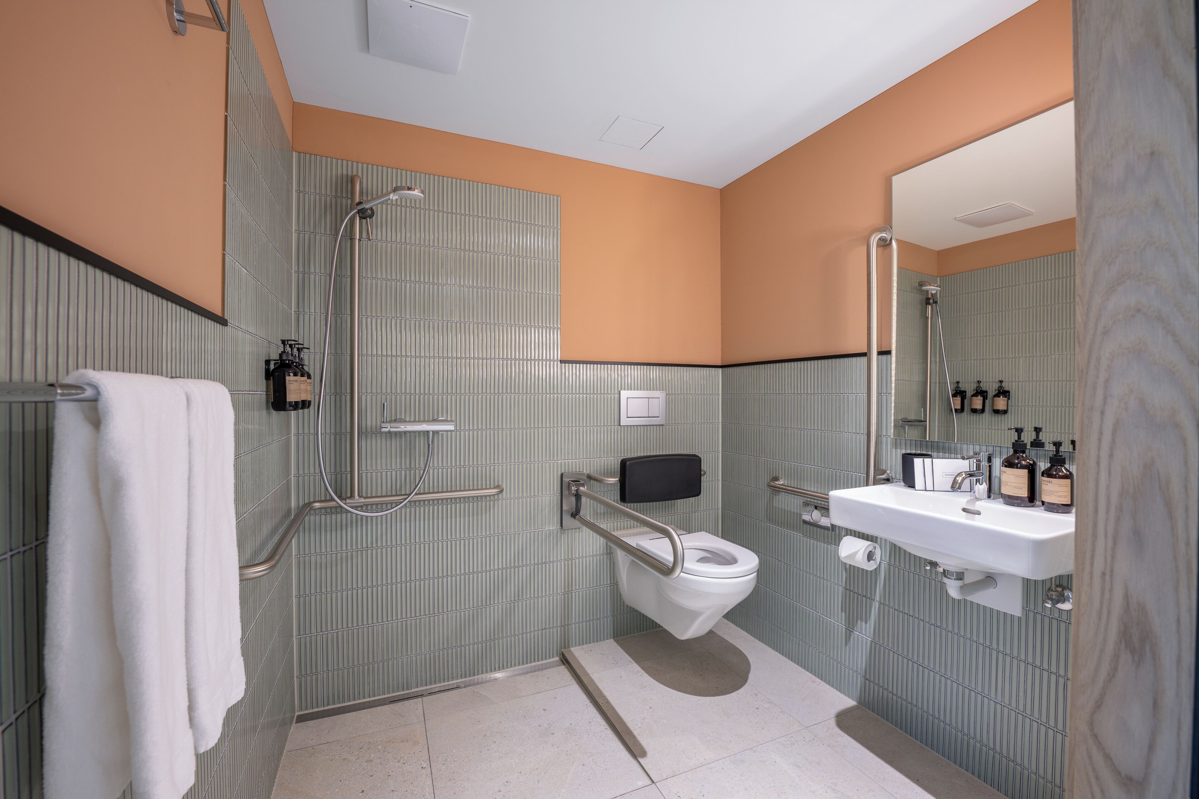 A bathroom with a toilet, sink, and shower.