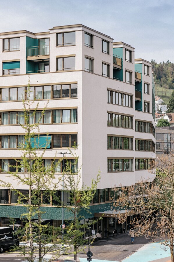 A multi-story hotel with a flat facade, large windows, and balconies.