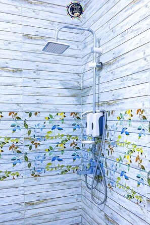 A shower with a wooden wall design and a floral pattern.
