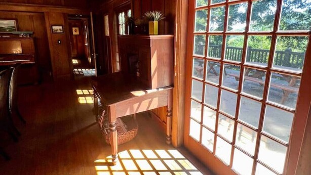 A wooden interior with a large window, a desk, and a chair. - Wildwood a great family house Sleeps up to 10!  Walk to trails! (Inverness)