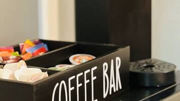 A coffee machine with a coffee bar below it.