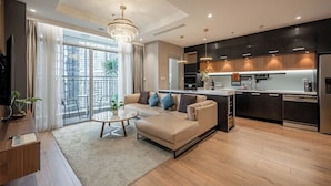 A modern living room with a sofa, coffee table, and a view of the city through large windows. - Landmark 81 & Vinhomes - ZEN Saigon Citypoint. (Ho Chi Minh City)