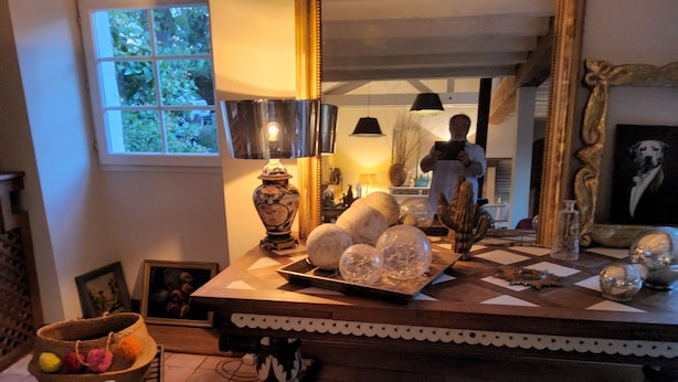 A dining table with decorative items, a vase, and a lamp.
