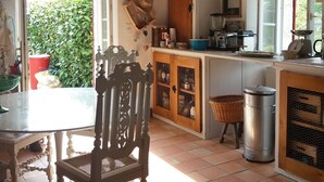 A kitchen with a wooden cabinet, a sink, and a window.