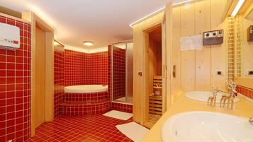 Een moderne badkamer met rode betegelde wanden, een houten wastafelmeubel, een bad en een douchecabine.