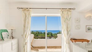 A room with a sliding glass door leading to a balcony, a white cabinet, a green mat, and a framed picture on the wall. - Casa Galo Verde, 4 persons, super sea view (Porches)
