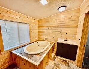 A wooden cabin bathroom with a bathtub, a sink, and a window. - Jack The Horse Lake Cabin -Pool Table-Wifi-Tub-Trails-Peaceful-Dining Closeby! (Marcell)