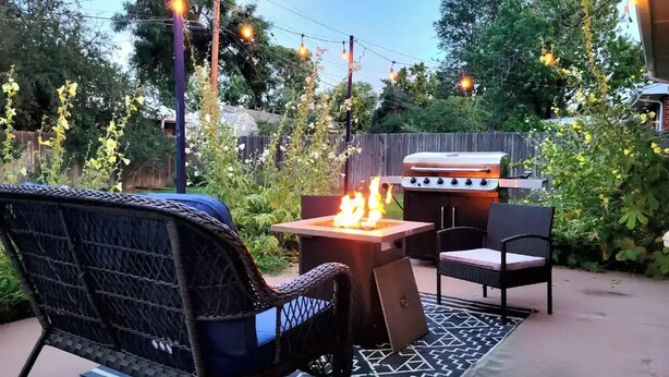 An outdoor patio with a fire pit, two chairs, and a grill. - 5BD Cozy, SouthGlenn Gem, Yard, Games, Shops, close to Downtown Littleton&Denver (Centennial)