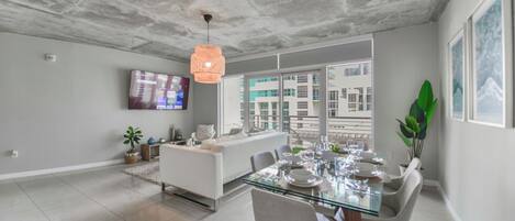 Deluxe Apartment | Living area | 50-inch Smart TV with cable channels