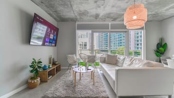 Deluxe Apartment | Living room | 50-inch Smart TV with cable channels