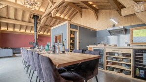 A modern kitchen with a wooden table and chairs, a built-in oven, and a variety of kitchenware. - MONT ROSE - LA PLAGNE TARENTAISE (LA PLAGNE TARENTAISE)