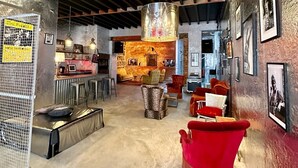 An interior with a bar area, seating, and artwork on the walls.