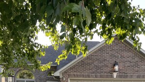 A residential house with a brick facade, a garage with multiple doors, and a well-maintained lawn. - 2 Bed/2 Bath Home in Andover area. Premier Host with 250+ 5-Star Reviews! (Lexington)