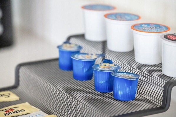 A tray with several containers, some with blue lids and others with white lids, placed on a textured surface.