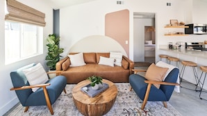 A modern living room with a sofa, two armchairs, a coffee table, and a large plant. - Private Guest House with Full Kitchen, 30 minutes to L.A. & Beach (Thousand Oaks)