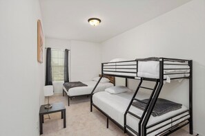 A bunk bed room with a small table and a lamp. - Peaceful Bayou Escape Close to LSU Campus - CL5626 (Baton Rouge)