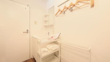 A small, clean bathroom with a white sink, a mirror, and a towel rack.