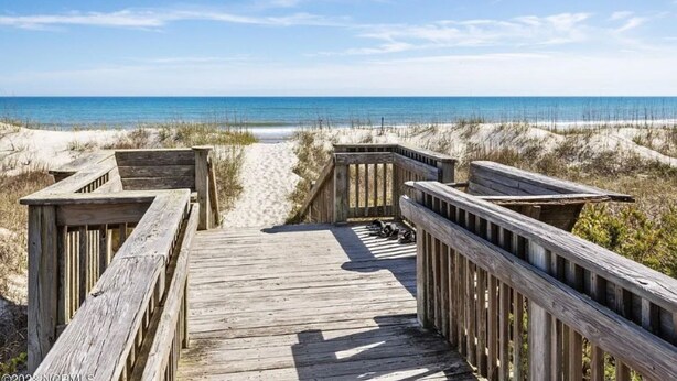 A wooden boardwalk leading to a beach with sand dunes and the ocean in the background. - Short walk to ocean and sound! NEW HOT TUB, FREE use of golf cart! Several decks (Emerald Isle)