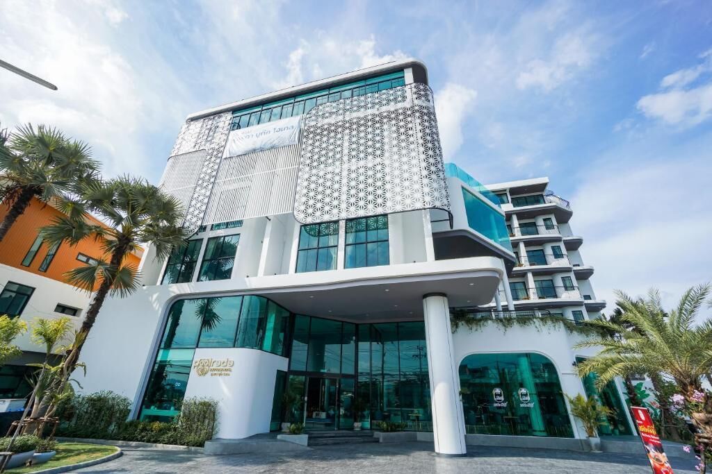 A modern hotel with a distinctive geometric facade, large glass windows, and a central entrance.