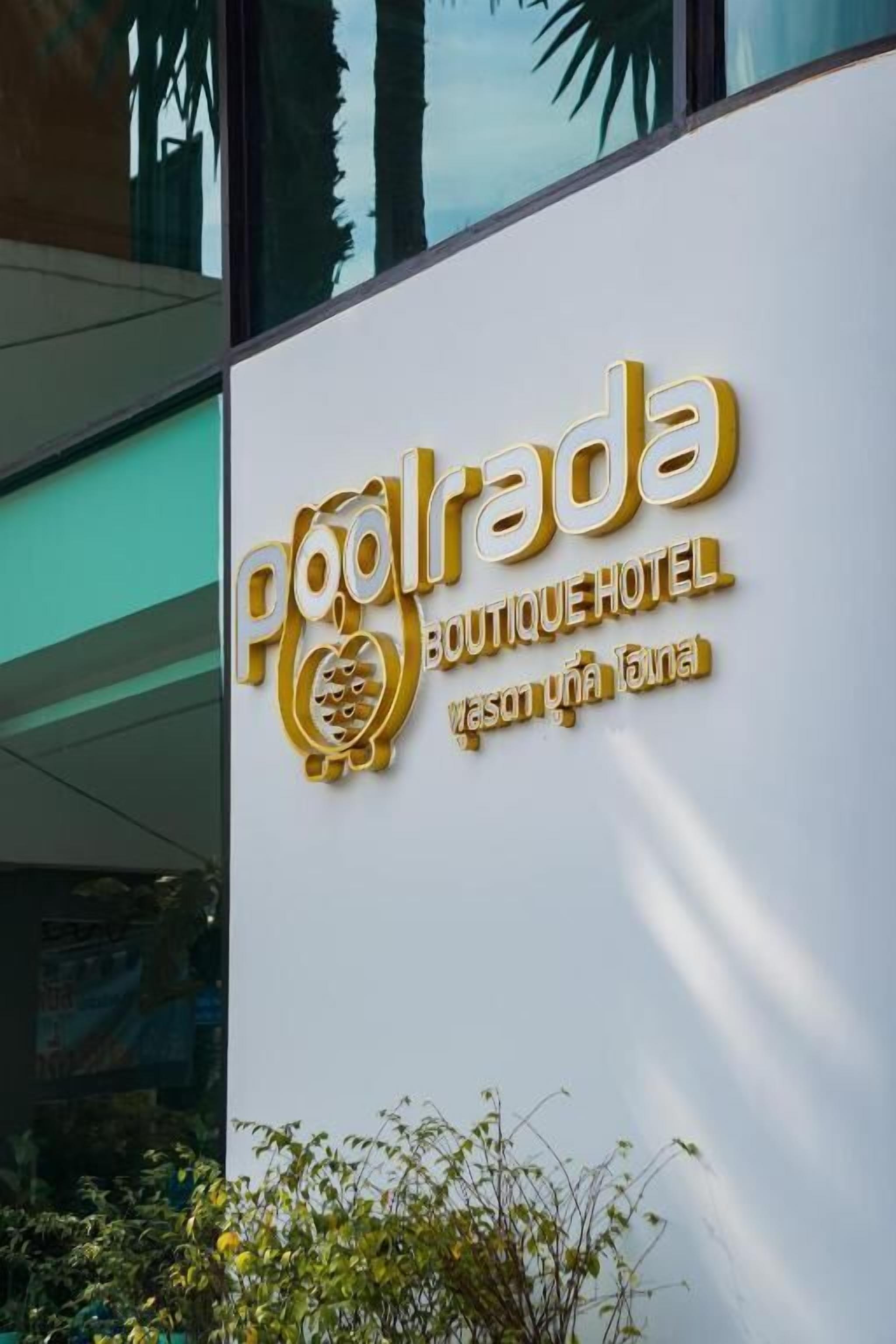 A sign for Poolrada Boutique Hotel with a stylized pool logo and Thai text.