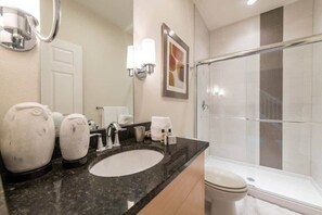 Bathtub, hair dryer, towels, shampoo