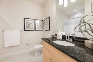 Bathtub, hair dryer, towels, shampoo