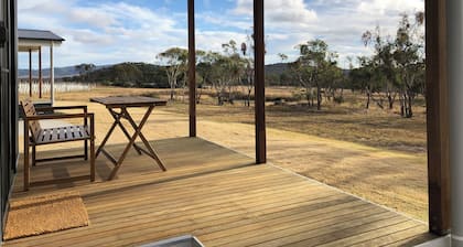 Modern studio cabin set amongst vineyards, bushland and grazing paddocks.
