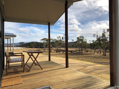 Modern studio cabin set amongst vineyards, bushland and grazing paddocks.