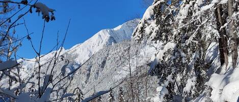 A snowy mountain landscape with clear blue skies.