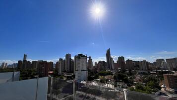 A city skyline with high-rise buildings and a clear blue sky.