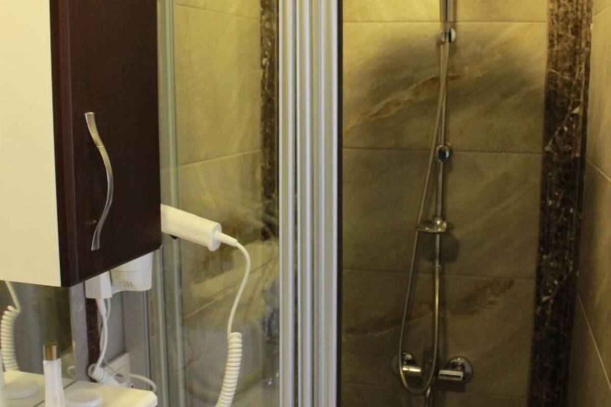 Bathroom | Shower, hair dryer, slippers, towels