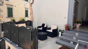 A terrace with outdoor seating, a staircase, and potted plants. - B&B Aurora (San Marcello Piteglio)