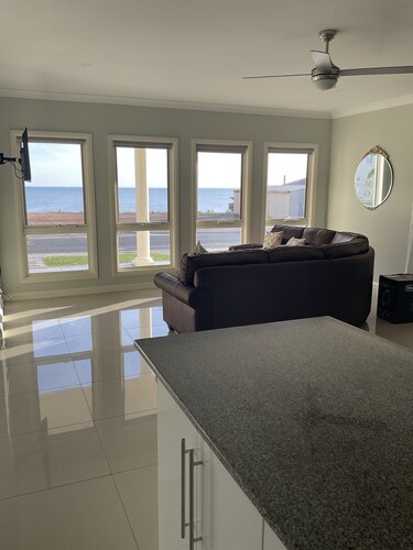 The happy place-Comfortable 3 bedroom home with sea views.  Steps to the beach. 