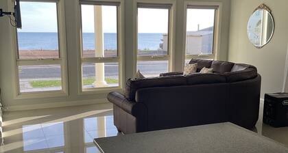 The happy place-Comfortable 3 bedroom home with sea views. Steps to the beach.