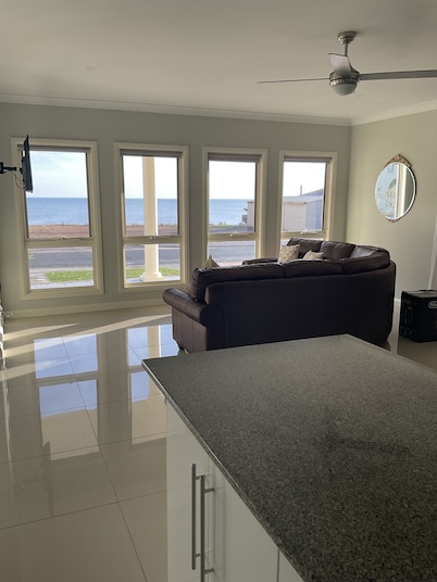 The happy place-Comfortable 3 bedroom home with sea views. Steps to the beach.