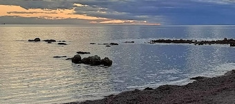 The happy place-Comfortable 3 bedroom home with sea views. Steps to the beach.