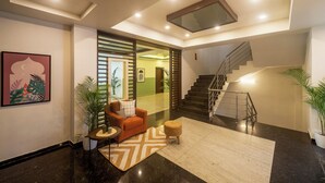 A modern interior with a staircase, a sofa, and a coffee table.