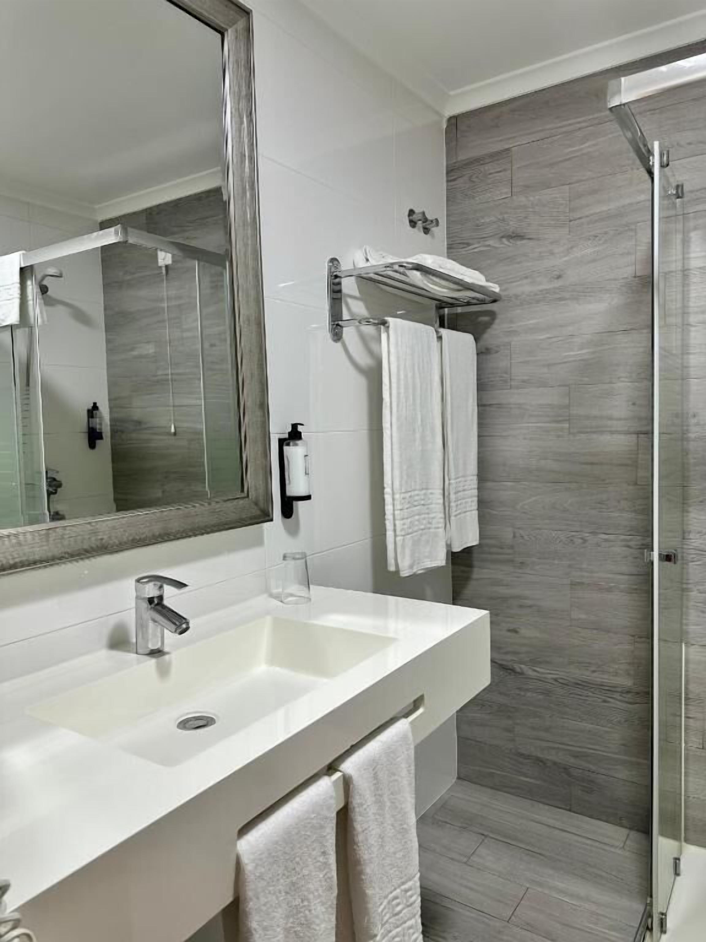 Shower, rainfall showerhead, hair dryer, towels