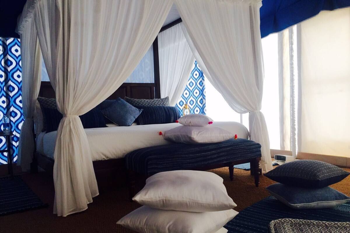 Desk, iron/ironing board, bed sheets